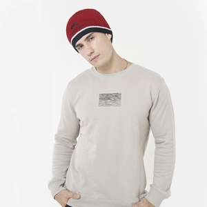 Detailed close-up of a red and black striped knit beanie with custom embroidery and sweatshirt