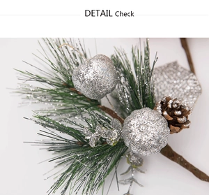 Close-up of silver glitter berries and pine cone on festive Christmas pick branch