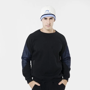 Detail view of a knitted beanie featuring a cool cheer embroidery and color block design