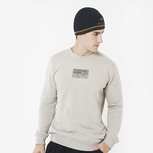Detail of navy knit beanie with striped trim and 'cool' cartoon embroidery