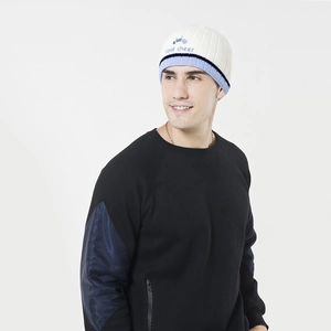 Detail of color-block knit beanie with 'cool cheer' embroidery and patchwork sleeve sweatshirt