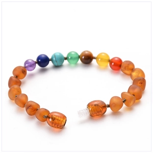 Vue détaillée des perles de pierres précieuses et du bracelet ambre bébé à fermoir à vis