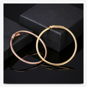 Detail of rose gold and gold 3mm cable wire open bracelets with sphere end caps