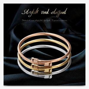 Detailed macro view of 18K gold-plated stainless steel cable bracelets in three colors