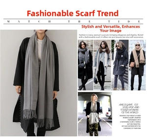 Detailed close-up of charcoal gray cashmere-style scarf with elegant fringe trim for winter