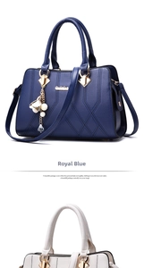Close-up of royal blue and beige tote bags featuring lychee texture and flower pendants