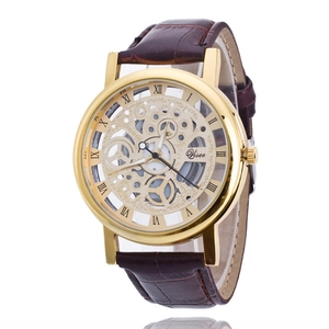Macro shot of gold hollow skeleton watch face with Roman numerals and brown leather strap