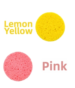 Macro detail of round lemon yellow and pink facial sponges with porous honeycomb texture