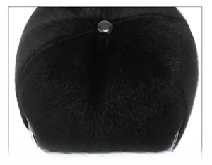 Close-up of winter wool baseball cap top button and soft black plush fabric detail