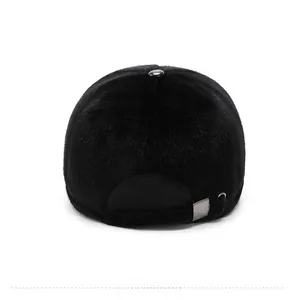 Detail view of the back of a black faux fur baseball cap with adjustable metal buckle