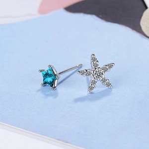Asymmetric blue star stud earrings with silver finish and cubic zirconia stones