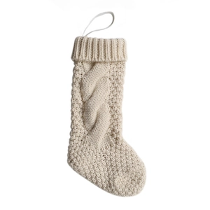 Detailed macro view of the cream white cable-knit texture on a mini Christmas stocking