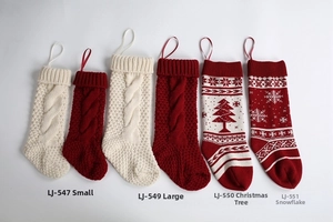 Detail of knitted Christmas stockings with cable patterns and festive holiday designs