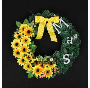 Detail of sunflower Christmas wreath with green pine needles and a polka dot bow