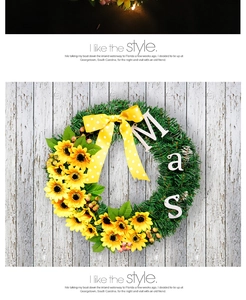 Detailed view of sunflower Christmas wreath with yellow bow and wooden Mas letter sign