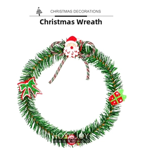 Close-up of a green PVC Christmas wreath with Santa Claus icon and red ribbon details