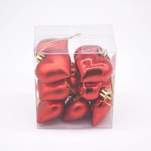 Detail of red heart-shaped Christmas ornaments in clear box, glossy and matte finishes
