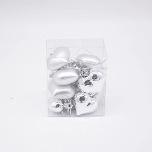 Set of silver heart-shaped Christmas ornaments in a clear plastic display box