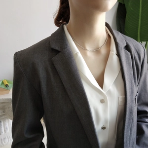 Close-up of a 925 sterling silver minimalist beaded choker necklace on a female model