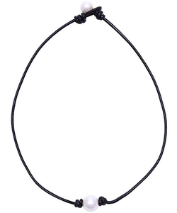 Detail view of double white freshwater pearls on a black leather cord necklace design