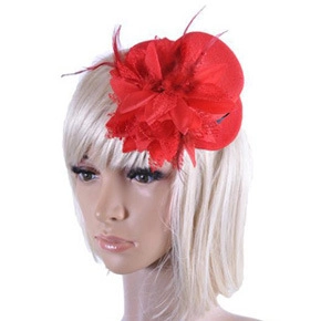 Detail of red feather mesh bridal fascinator with floral design on mannequin head
