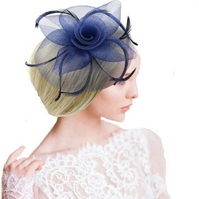 Detail view of navy blue fascinator hat with elegant feathers and mesh veil on a model
