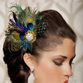 Detail of peacock feathers, blue netting, and rhinestone centerpiece on bridal headpiece