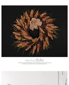 Detailed view of fall harvest wreath with dried wheat stalks and a rustic burlap bow