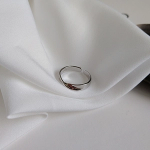 Detail of 925 sterling silver Mobius ring showing S925 hallmark on white silk