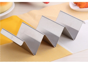 Macro detail of wave-shaped stainless steel taco holder for 4 shells on a dining table