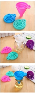 Close-up of colorful foldable silicone funnels showing folding mechanics on wooden table