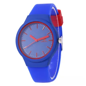 Detail view of electric blue silicone sports watch with bold red dial accents and hands
