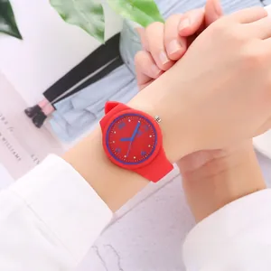 Close-up of a stylish red and blue silicone sports watch worn on a wrist for teenagers