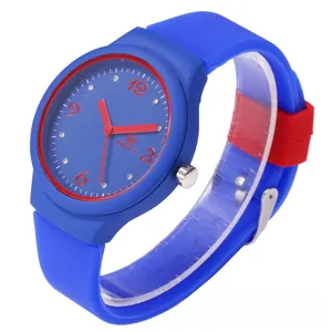 Detailed view of quartz watch featuring blue silicone strap and red crystal hour markers