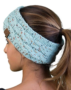 Close-up of mint green cable-knit winter headband with colorful flecks and C.C logo