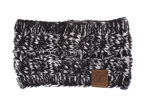 Detail of black and white knit ear warmer with cable twist pattern and brown C.C leather label