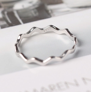 Macro shot of S925 sterling silver stamp on the polished wavy minimalist ring