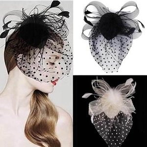 Detail showing polka dot mesh veil with feathers and bow in black and white styles