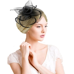 Detailed close-up of an elegant black feather fascinator with mesh on a professional model