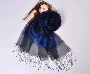 Detailed view of silk organza scarf with blue-black gradient and delicate fringe tassels