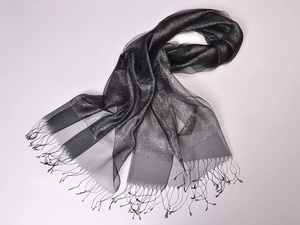 Close-up of black silk organza scarf featuring metallic threads and delicate fringe detail