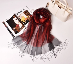 Detail of red and black gradient silk organza scarf with shimmer and fringe tassels