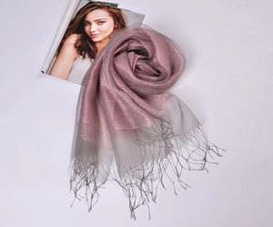 Detail of pink and grey gradient silk scarf with gold tinsel, fringe, and sheer texture