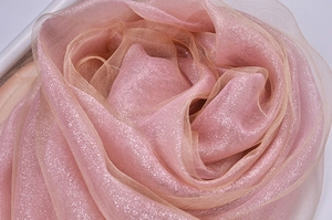 Detail of pink silk organza scarf with gold glitter and elegant layered texture