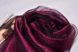 Detailed view of shimmering magenta silk organza fabric with soft pleats and elegant texture