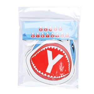 Detail view of shark themed happy birthday banner kit with blue paper cards and ribbon