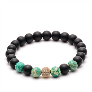 Close-up of 8mm volcanic stone and tiger eye beads with a gold zircon pavé ball