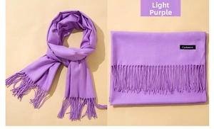 Close-up of light purple cashmere scarf showing soft texture and long tassel fringe