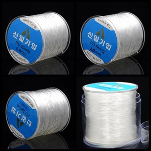 Detailed macro view of crystal elastic string rolls in multiple sizes for DIY jewelry making