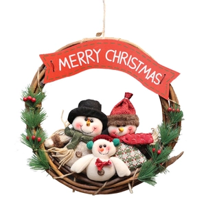 Christmas wreath with three plush snowmen, pine needles, and Merry Christmas banner